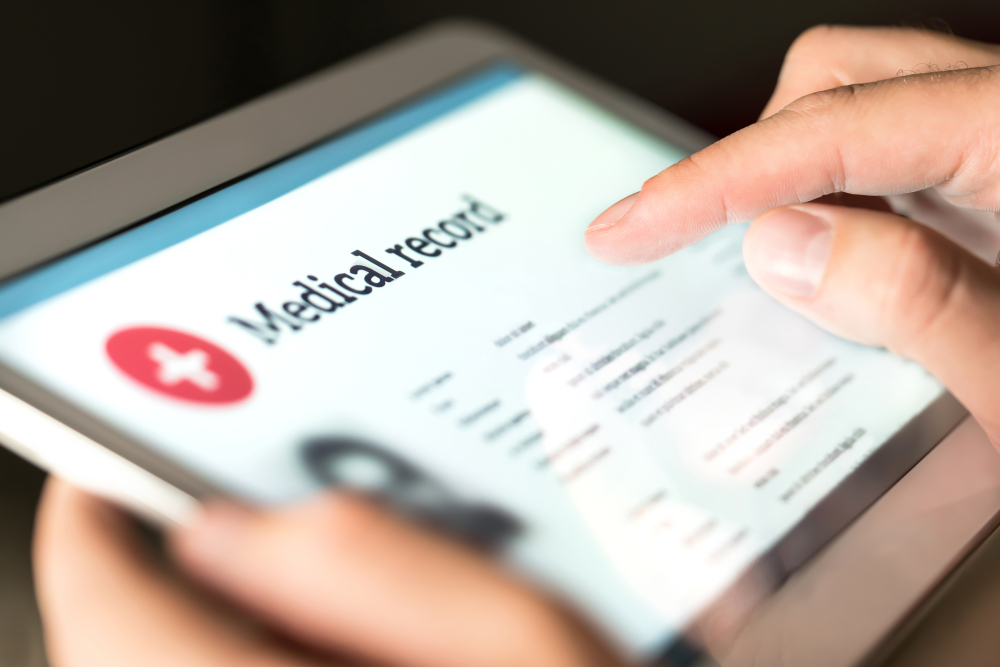 A tablet with the words 'medical record' on the screen